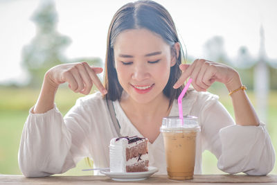 Close-up of woman sitting with breakfast on table at restaurant