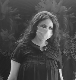 Portrait of beautiful woman standing against wall