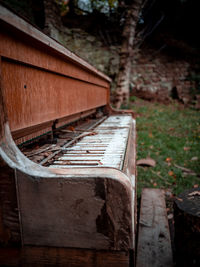 Close-up of old railroad track amidst trees on field