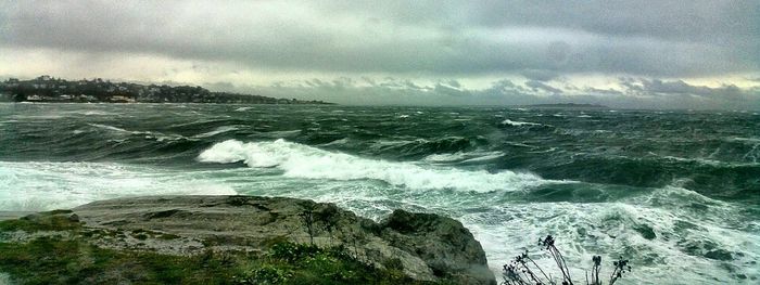 Scenic view of sea against cloudy sky