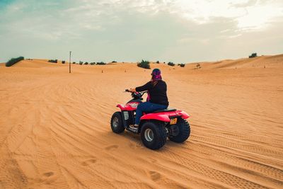 Man riding motorcycle on desert