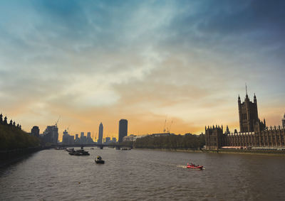 Scenic view of sea and buildings against sky during sunset