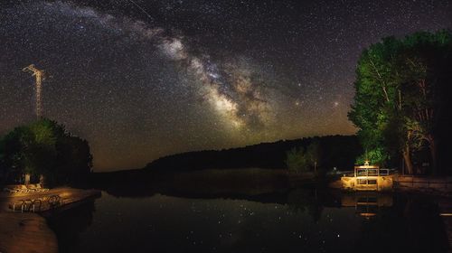 Scenic view of calm lake against star field