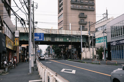 Road by buildings in city