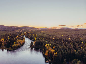 Scenic view of land against clear sky during sunset