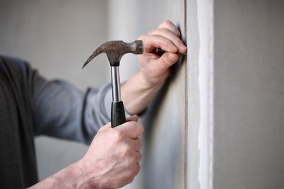 Midsection of man working on wall