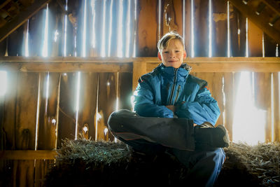 Portrait of young woman sitting on field