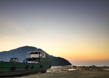 View of boats in sea at sunset