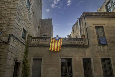 Buildings displaying the catalan flag in girona, spain