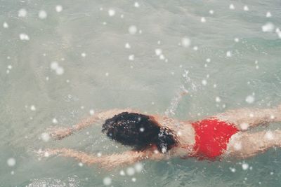 Swimming underwater in pool