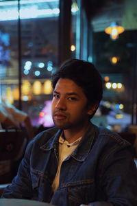 Portrait of young man sitting in restaurant