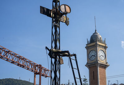 Low angle view of clock tower against blue sky