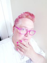 Close-up portrait of woman wearing eyeglasses at home