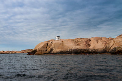 Scenic view of calm sea against cloudy sky