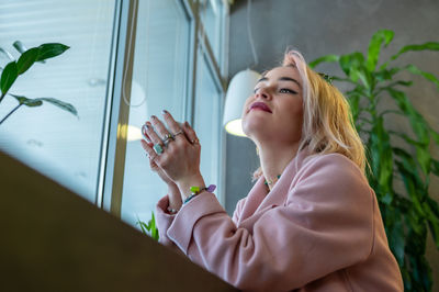 Young woman is drinking coffee in a cafe.