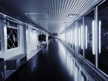 People in illuminated corridor