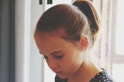 Close-up portrait of young woman at home