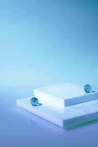 Empty scene with square podium on holographic blue background