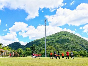 Group of people on landscape against the sky