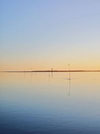 Scenic view of sea against clear sky during sunset