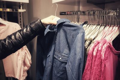 Close-up of woman buying clothes at shop