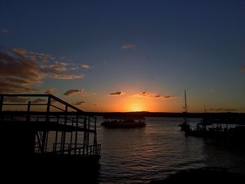 Silhouette of pier at sunset