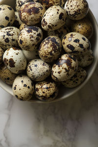 Quail eggs on a marble table.