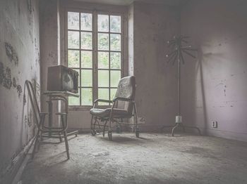 Empty bench in abandoned house
