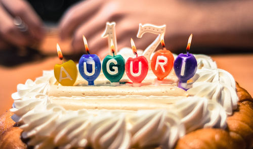 Birthday cake on table with burning candles 