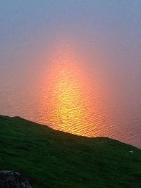 Scenic view of land against sky during sunset