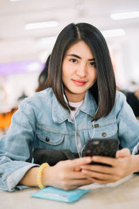 Portrait of beautiful woman sitting on table