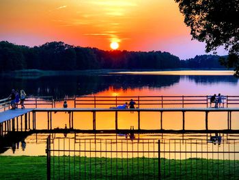 Scenic view of lake against orange sky