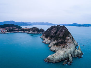 Panoramic view of sea and mountains against sky