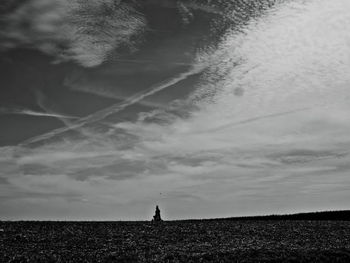 Silhouette man on field against sky