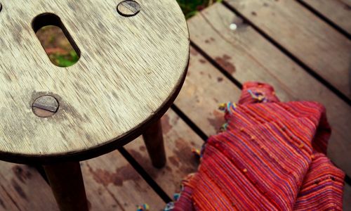 High angle view of wooden bench on table