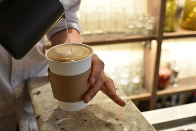 Close-up of barista making coffee