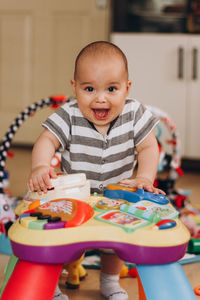 Portrait of cute boy smiling at home