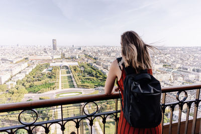 Rear view of woman looking at cityscape