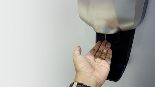 Close-up of woman hand over white background