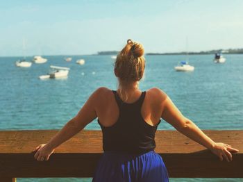 Rear view of woman looking at sea against sky