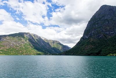 Scenic view of lake and mountains against sky