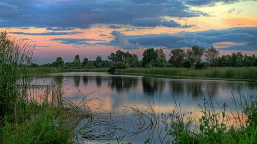 Scenic view of lake at sunset