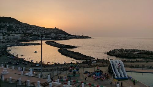 High angle view of people at beach during sunset