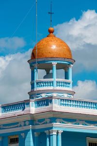 Low angle view of building against cloudy sky