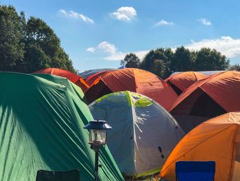 Tent on landscape against cloudy sky