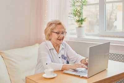 Businesswoman using laptop at home