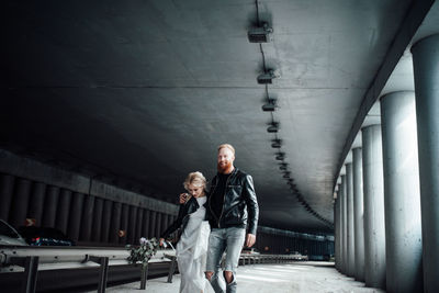 Full length of couple walking on bridge