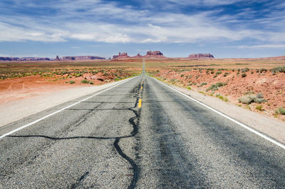 Road passing through landscape against sky