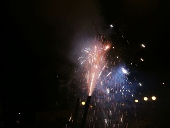 Low angle view of firework display at night