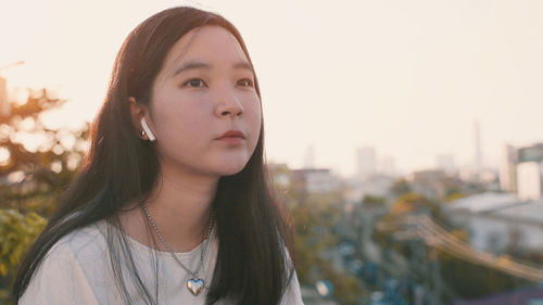 Portrait of beautiful woman against sky